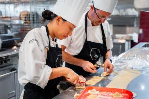 University of Hawaii culinary students learning food science and preparation techniques in a professional kitchen